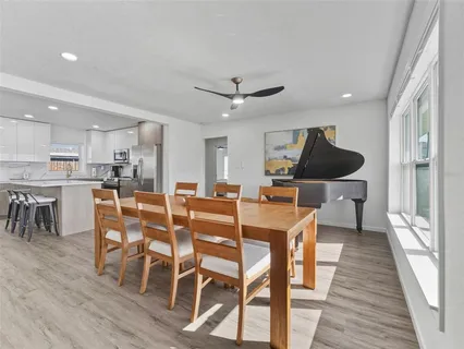 a view of a dining room with furniture and wooden floor