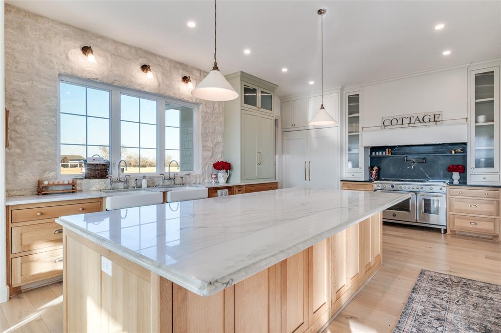 5165 Hartlee Field Road Denton, TX 76208 - Photo 26 of 39 a large kitchen with stainless steel appliances granite countertop a sink a oven and a large window with wooden floor
