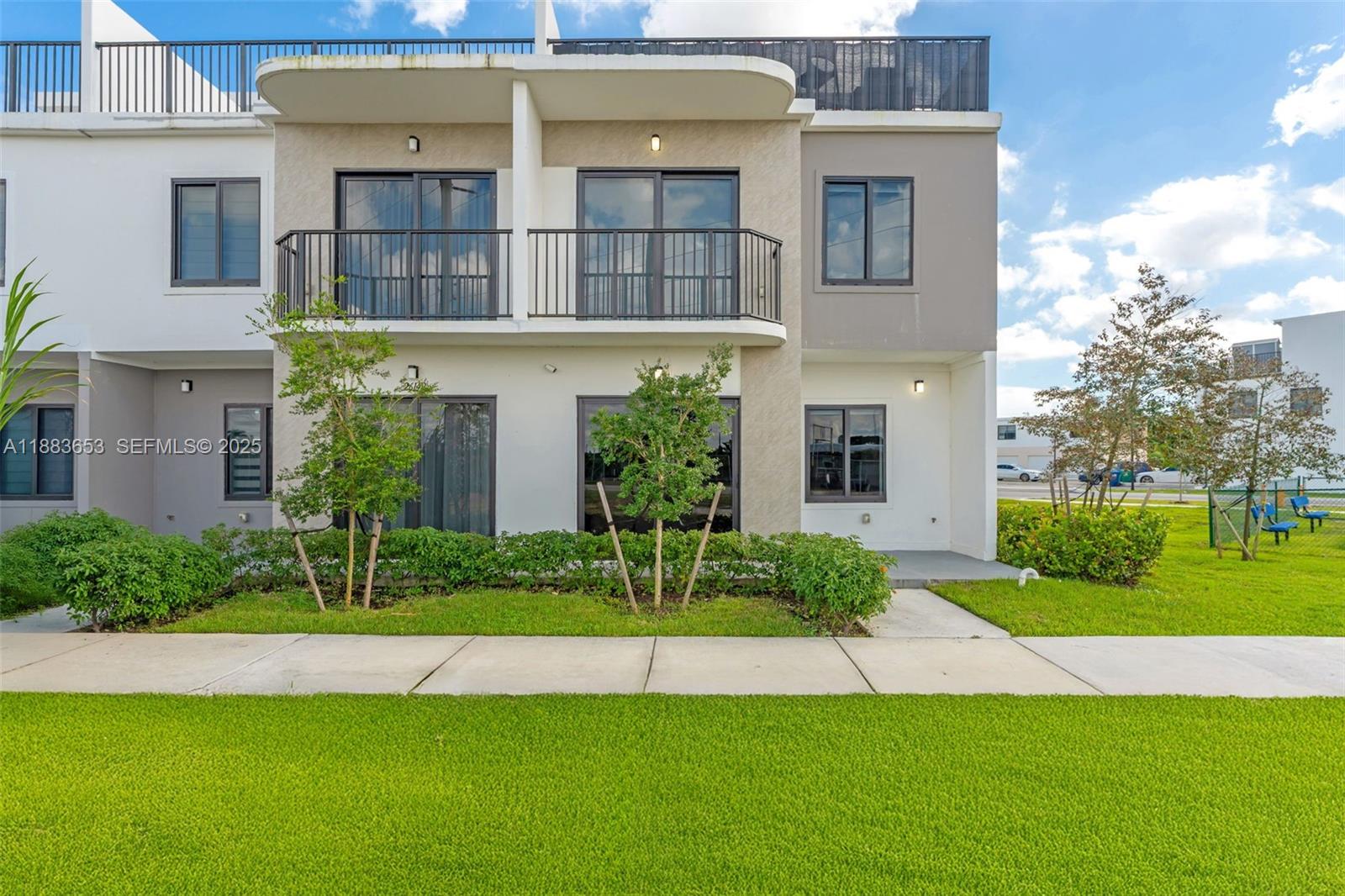 26144 Southwest 146th Court Homestead, FL 33032 - Photo 1 of 35 Beautiful corner unit with modern façade, landscaped front area, and a kids park right on the corner.