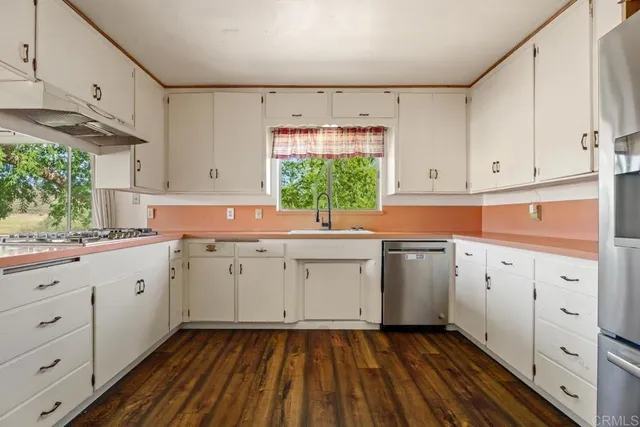 a kitchen with sink cabinets and window