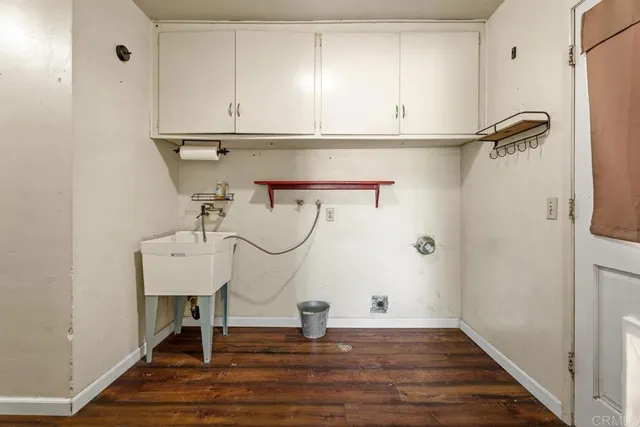 a view of a room with wooden floor and cabinets