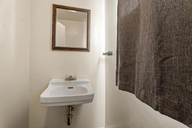 a bathroom with a sink a mirror and vanity