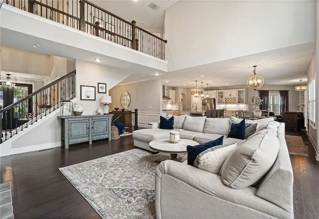 a dining room with wooden floor a chandelier a wooden table and chairs