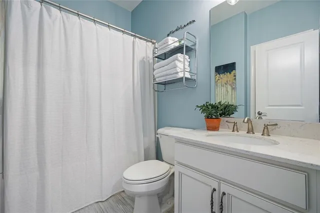 a spacious bathroom with a double vanity sink a mirror and a bathtub