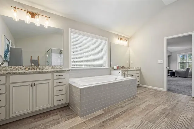 a spacious bedroom with a bed and walk in closet