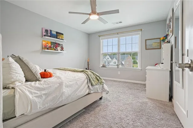 a view of a swimming pool with a yard and sitting area