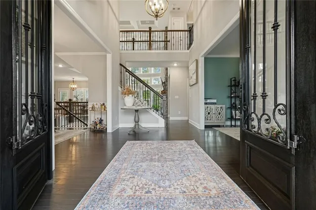 a dining room with furniture a chandelier and wooden floor