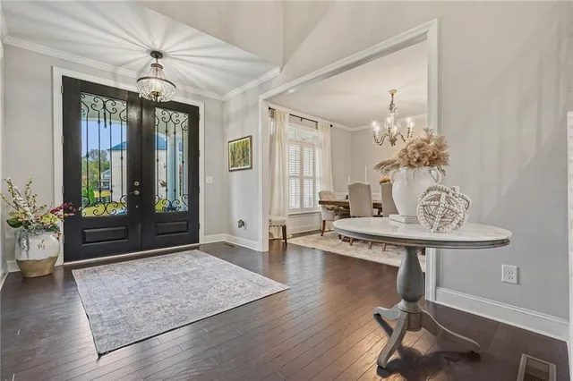 a view of a dining room with furniture and chandelier