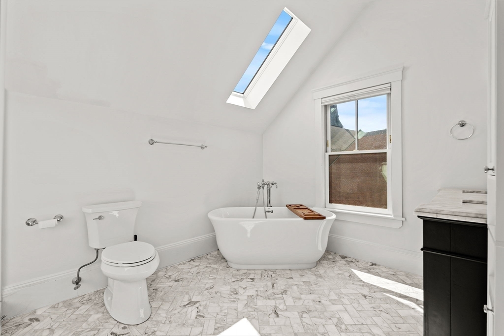 23 Union Street, Unit 2 Salem, MA 01970 - Photo 23 of 33 a bathroom with a toilet sink and mirror