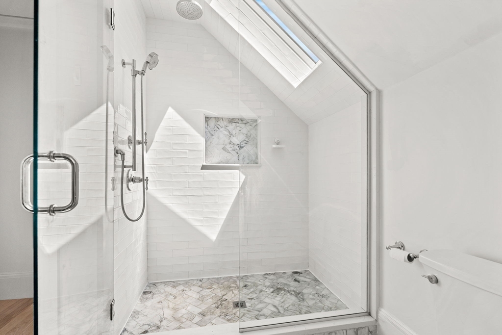 23 Union Street, Unit 2 Salem, MA 01970 - Photo 24 of 33 a bathroom with a glass shower door mirror and window
