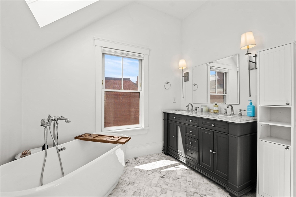23 Union Street, Unit 2 Salem, MA 01970 - Photo 25 of 33 a bathroom with a tub sink and mirror