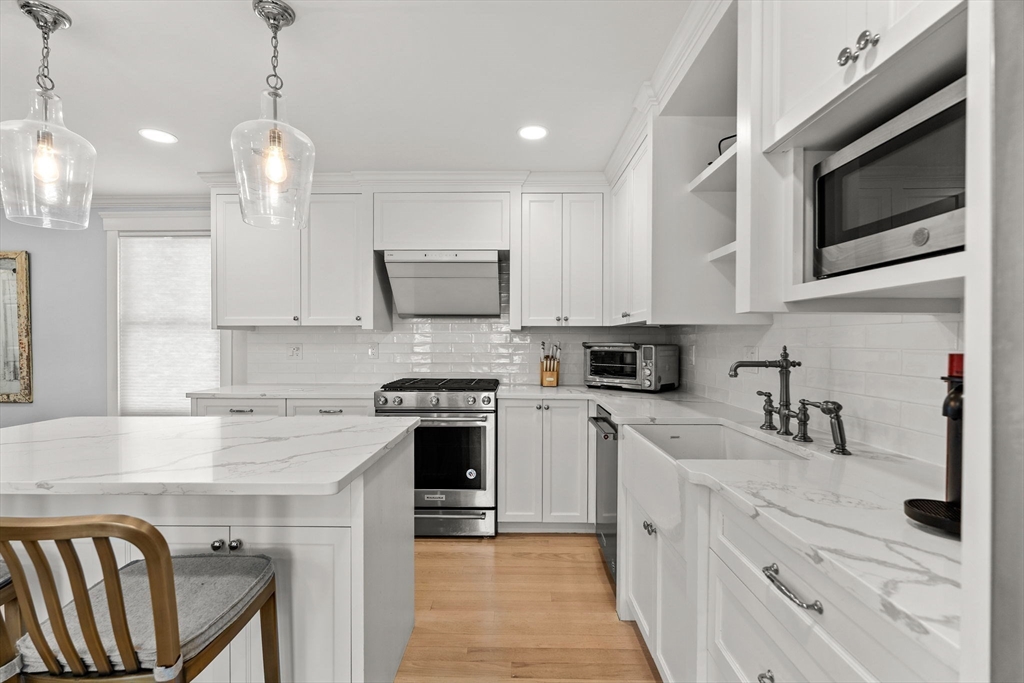 23 Union Street, Unit 2 Salem, MA 01970 - Photo 3 of 33 a kitchen with stainless steel appliances granite countertop a stove a sink and a microwave