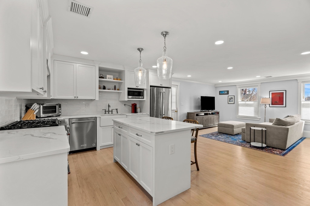 23 Union Street, Unit 2 Salem, MA 01970 - Photo 5 of 33 a kitchen with white cabinets and stainless steel appliances