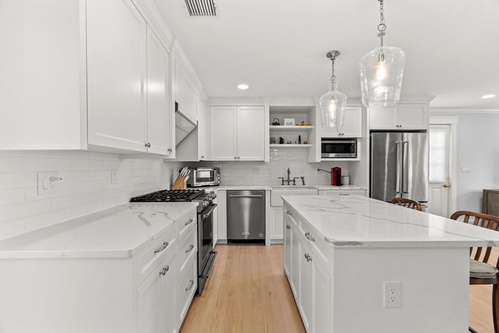 23 Union Street, Unit 2 Salem, MA 01970 - Photo 6 of 33 a kitchen with a sink a stove a refrigerator and white cabinets