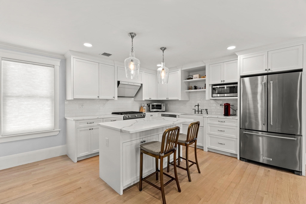 23 Union Street, Unit 2 Salem, MA 01970 - Photo 7 of 33 a kitchen with stainless steel appliances a refrigerator a stove a sink and a refrigerator
