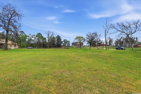 a view of a field of grass and trees