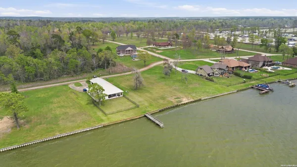 an aerial view of residential houses with outdoor space and swimming pool