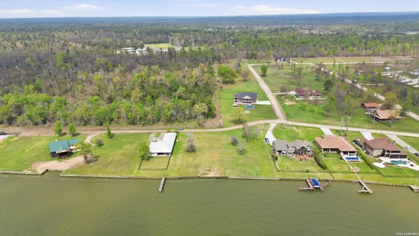 a view of a large pool with an ocean in the background
