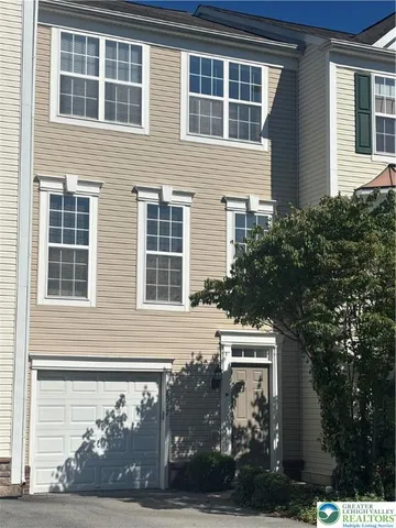 a front view of a house with plants