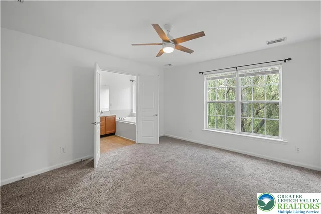 a view of a livingroom with a ceiling fan and window