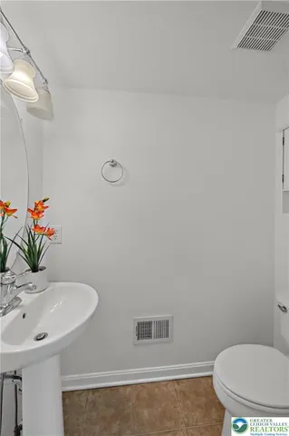 a bathroom with a sink toilet and a mirror