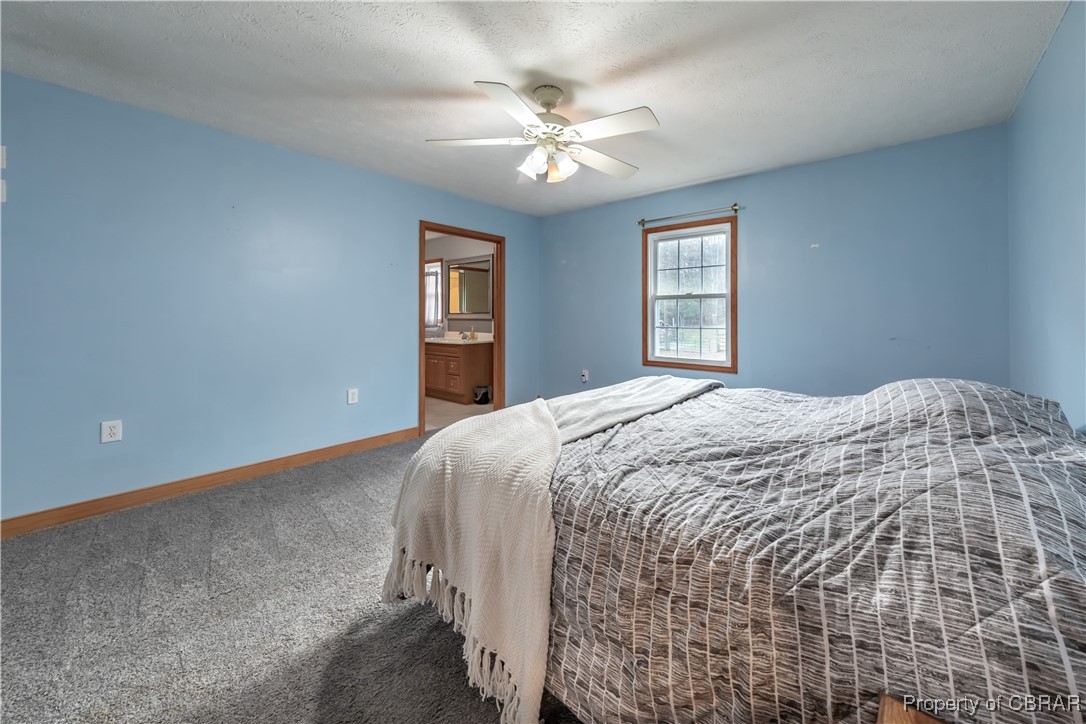 9534 Gee Farm Road Gloucester, VA 23061 - Photo 30 of 48 Bedroom featuring ceiling fan, carpet, and ensuite bathroom