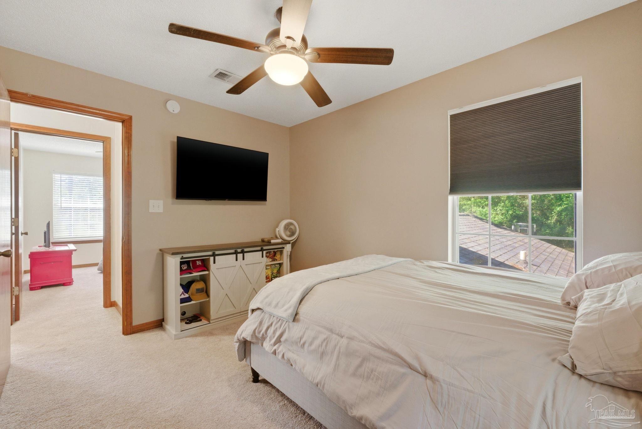 6870 Martin Road Milton, FL 32570 - Photo 27 of 48 a bedroom with a bed and a flat screen tv
