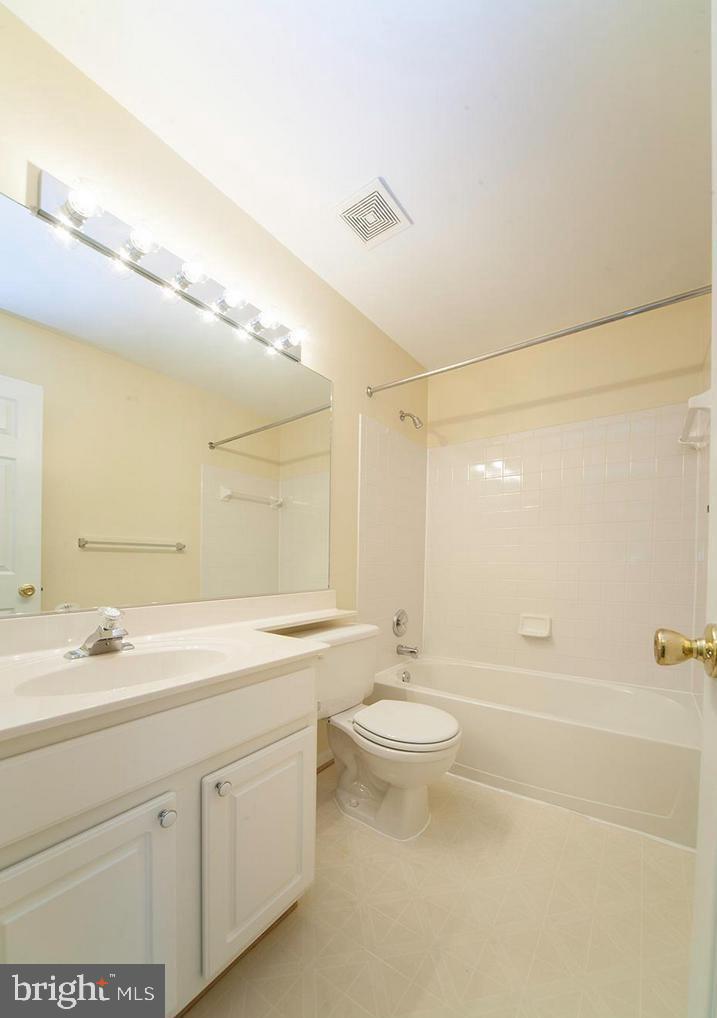 6727 Sullivan Way Alexandria, VA 22315 - Photo 17 of 24 a bathroom with a double vanity sink a toilet and a shower