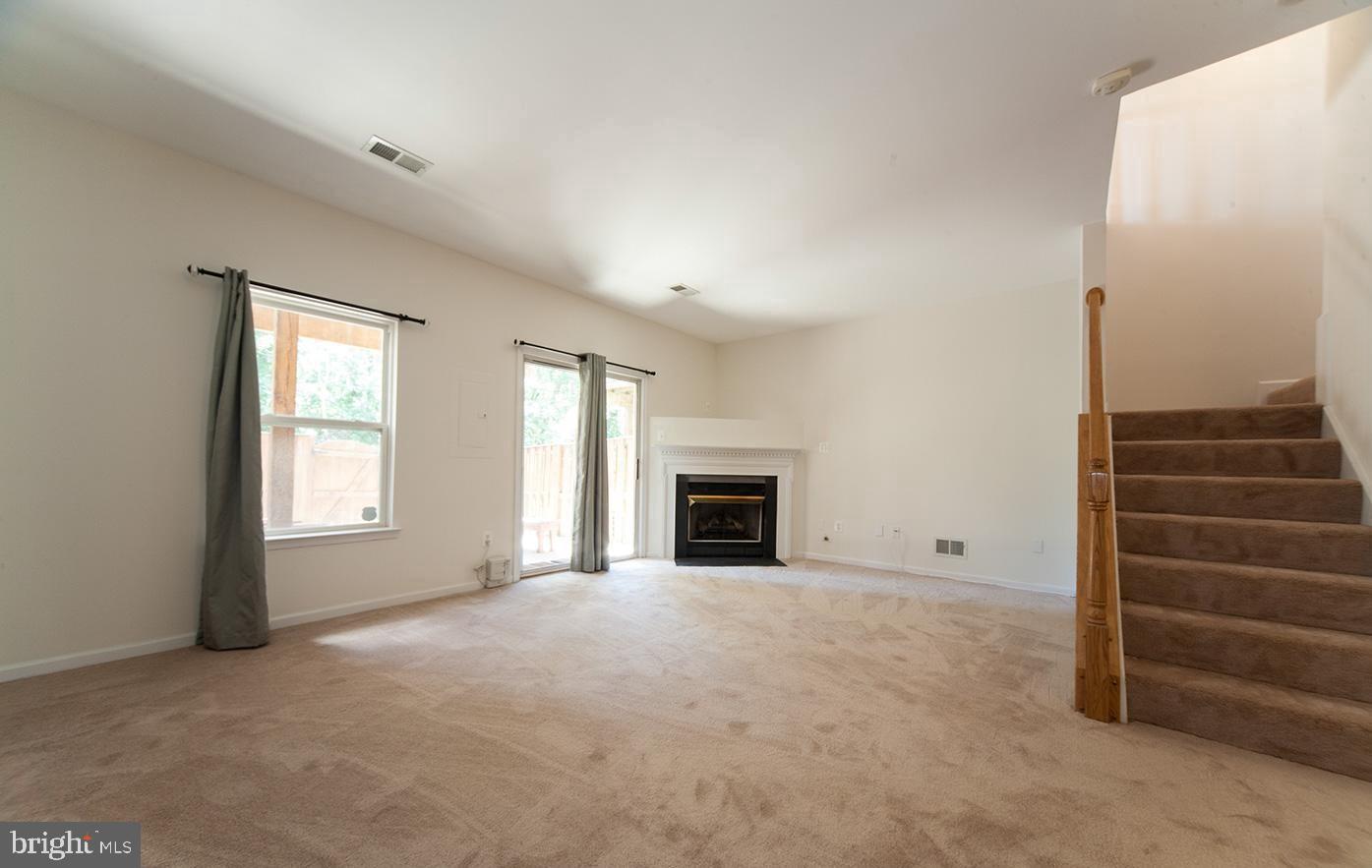 6727 Sullivan Way Alexandria, VA 22315 - Photo 20 of 24 a view of an empty room with a fireplace and a window