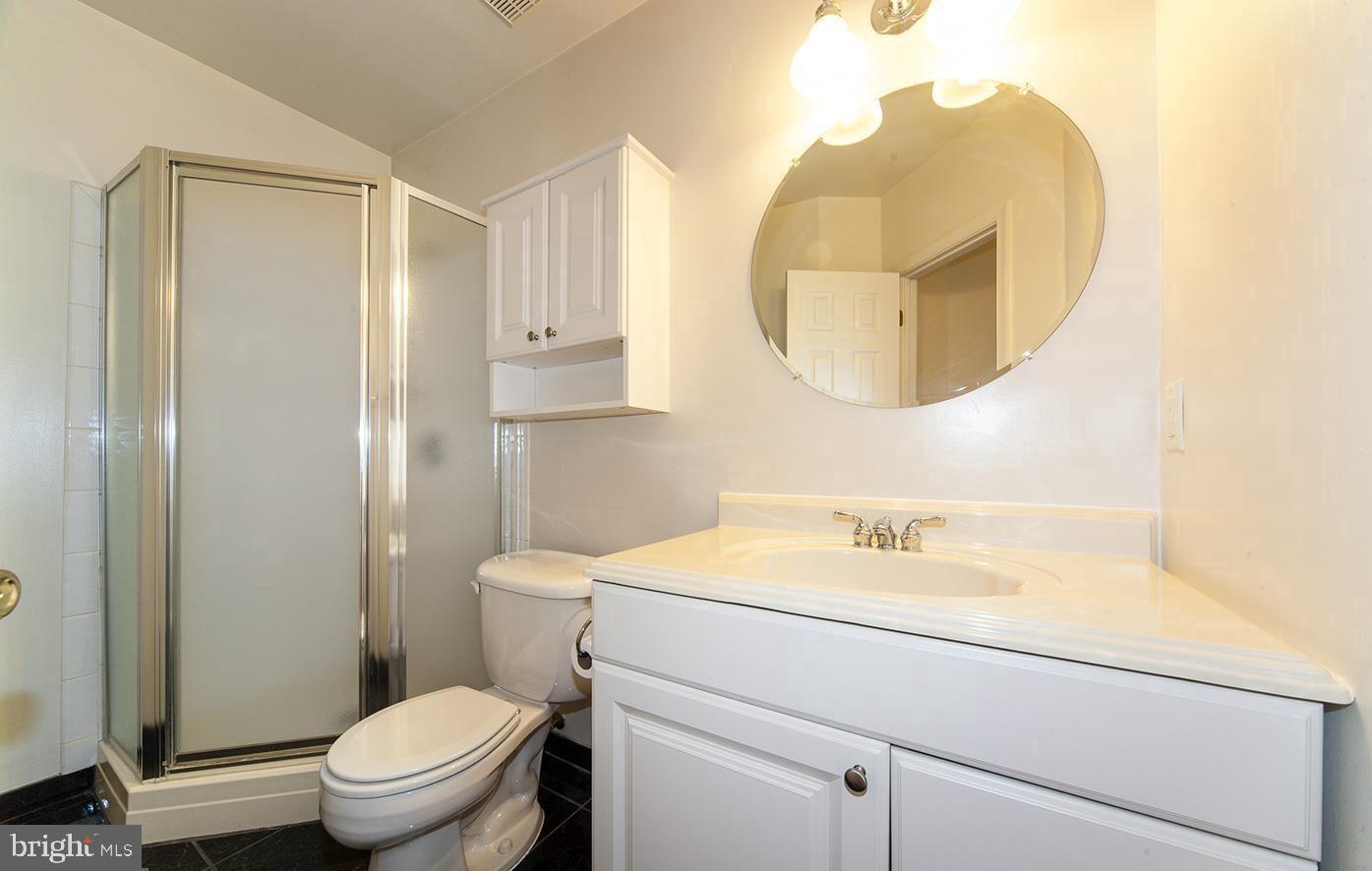 6727 Sullivan Way Alexandria, VA 22315 - Photo 21 of 24 a bathroom with a sink a toilet and a mirror