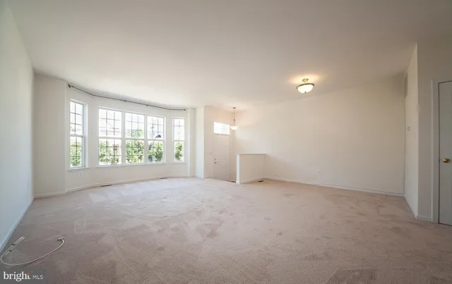 an empty room with windows and entrance