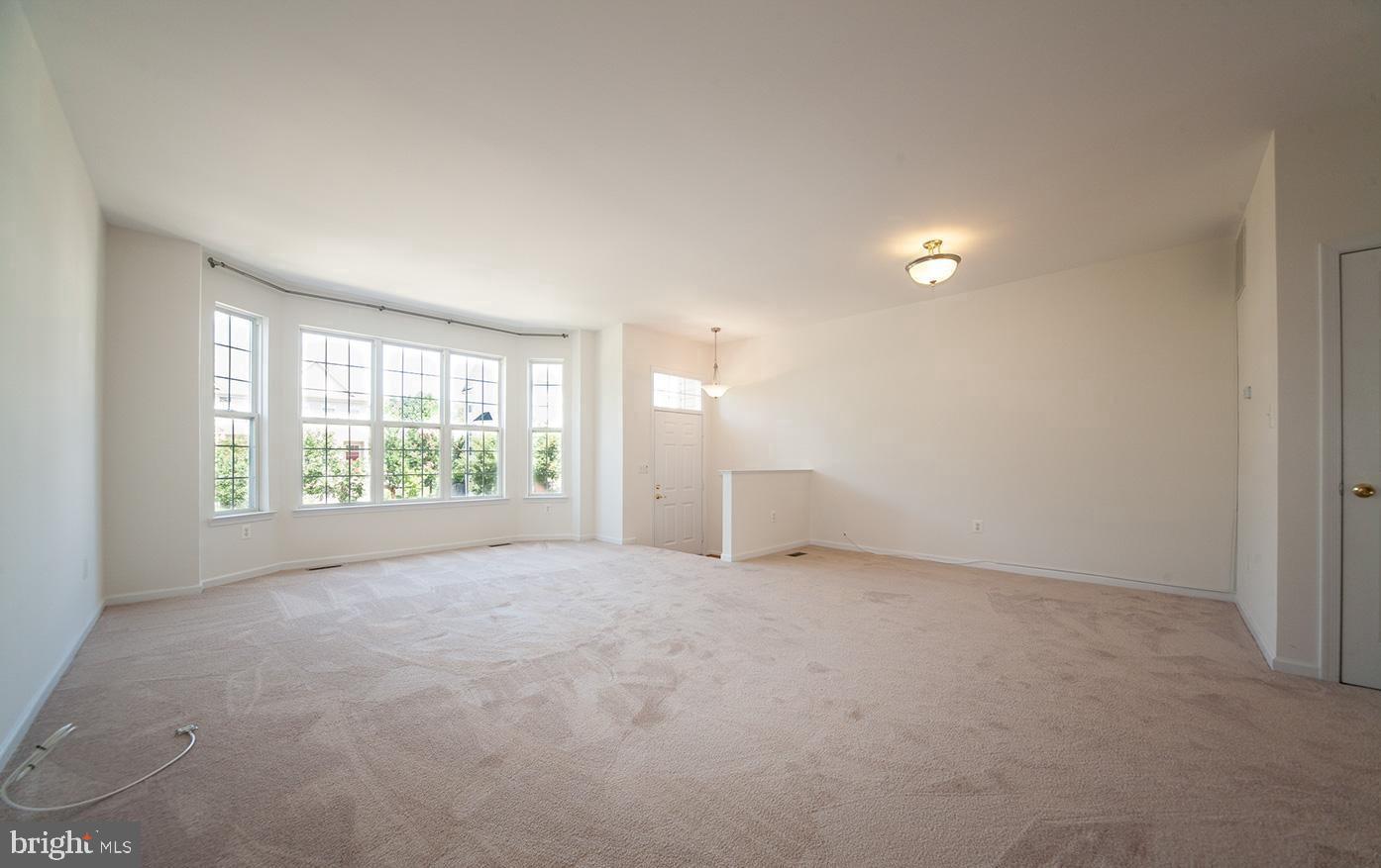 6727 Sullivan Way Alexandria, VA 22315 - Photo 3 of 24 an empty room with windows and entrance
