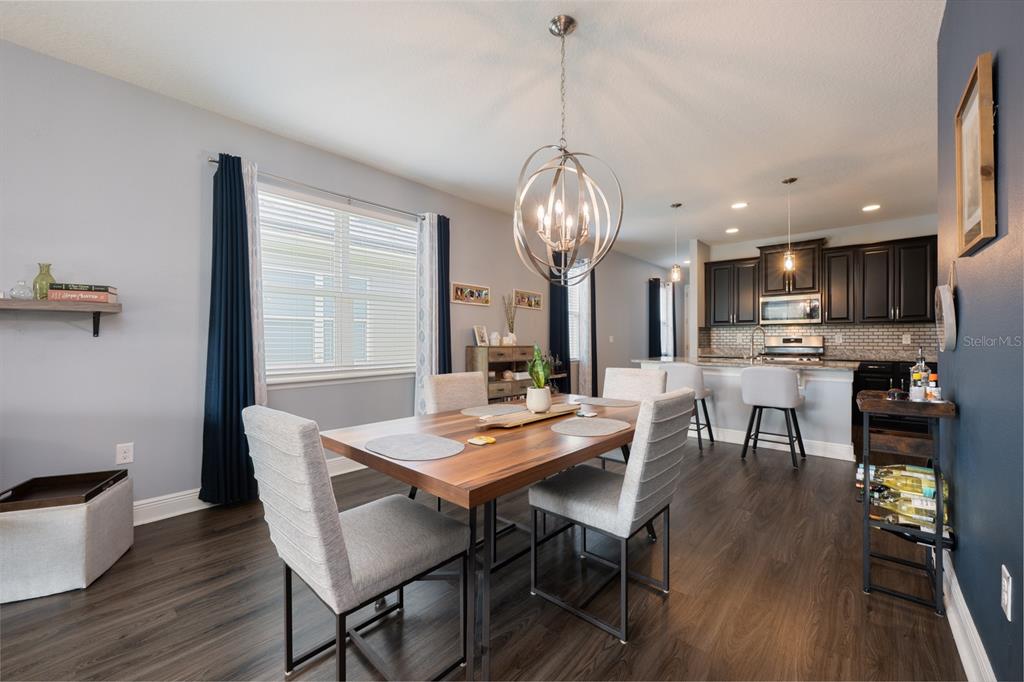 1398 Riley Circle Deland, FL 32724 - Photo 6 of 29 a view of a dining room with furniture a chandelier and wooden floor