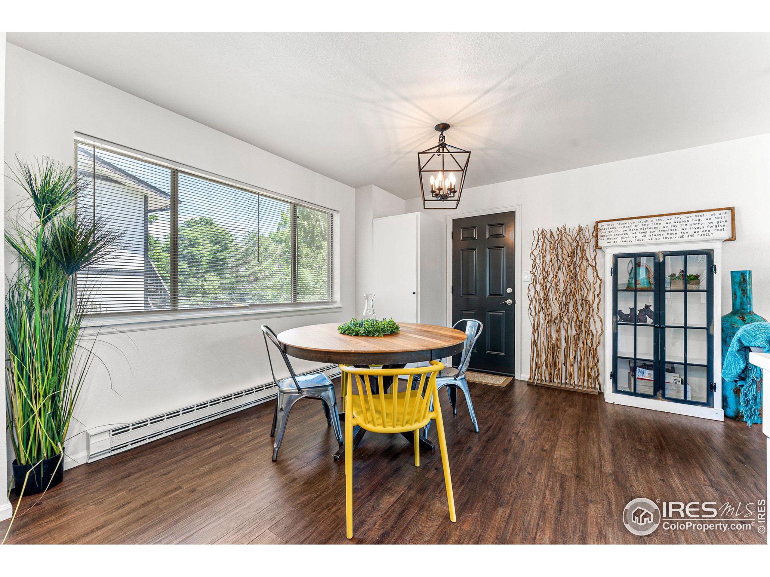 2408 Orchard Place Fort Collins, CO 80521 - Photo 12 of 36 a view of a dining room with furniture window and wooden floor