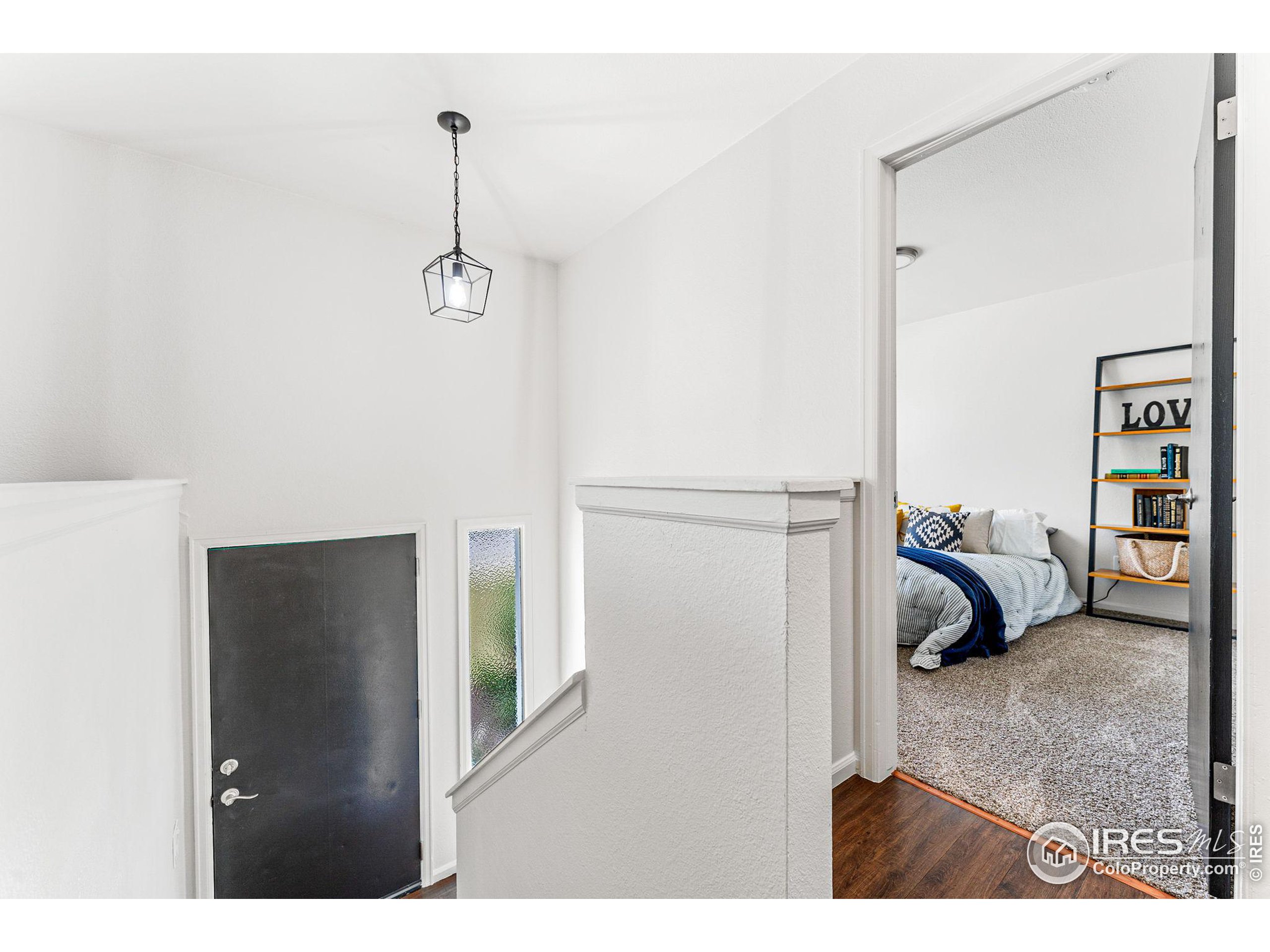 2408 Orchard Place Fort Collins, CO 80521 - Photo 16 of 36 a bedroom with a bed and a walk in closet