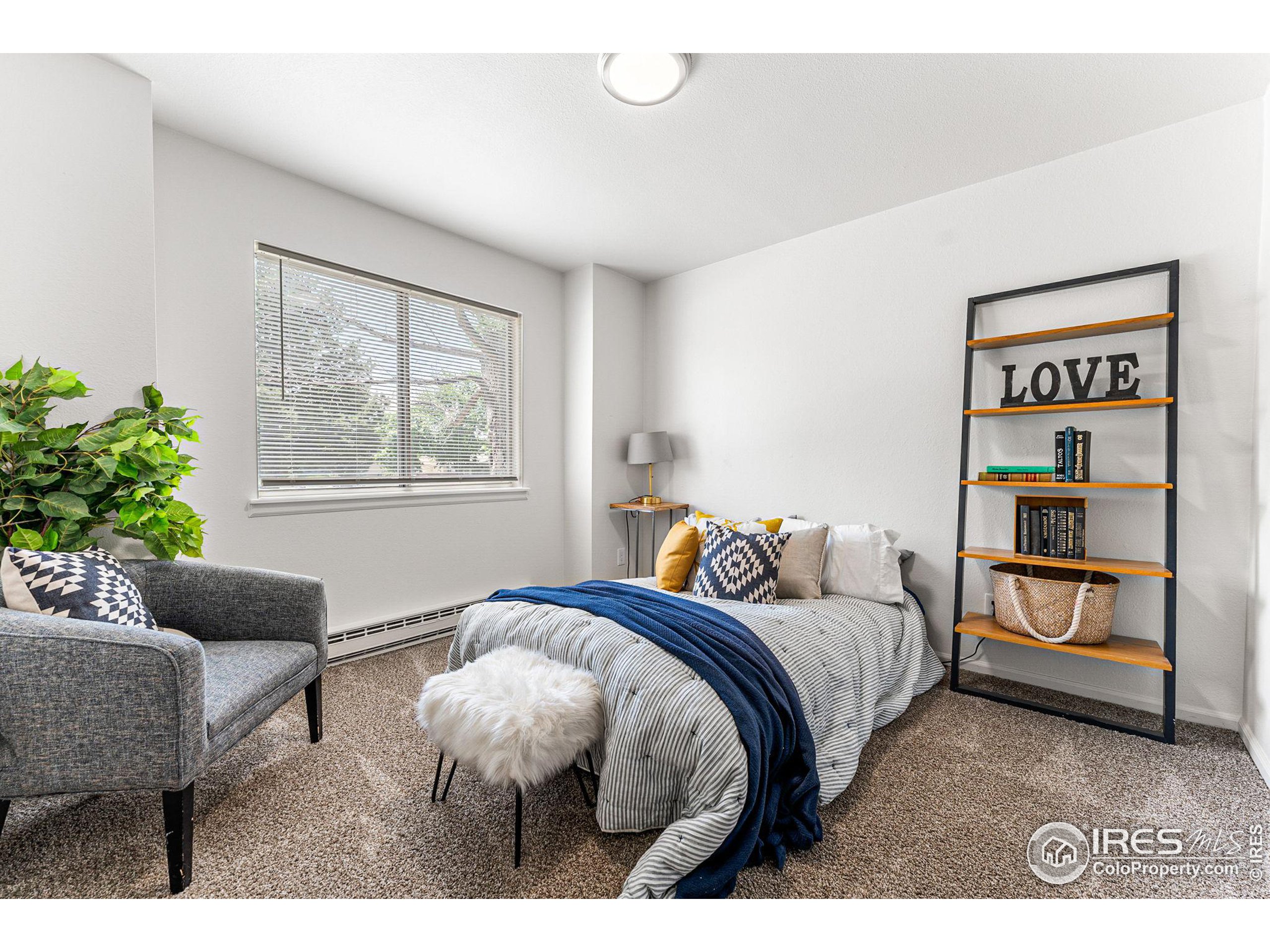 2408 Orchard Place Fort Collins, CO 80521 - Photo 17 of 36 a bedroom with a bed and a couch