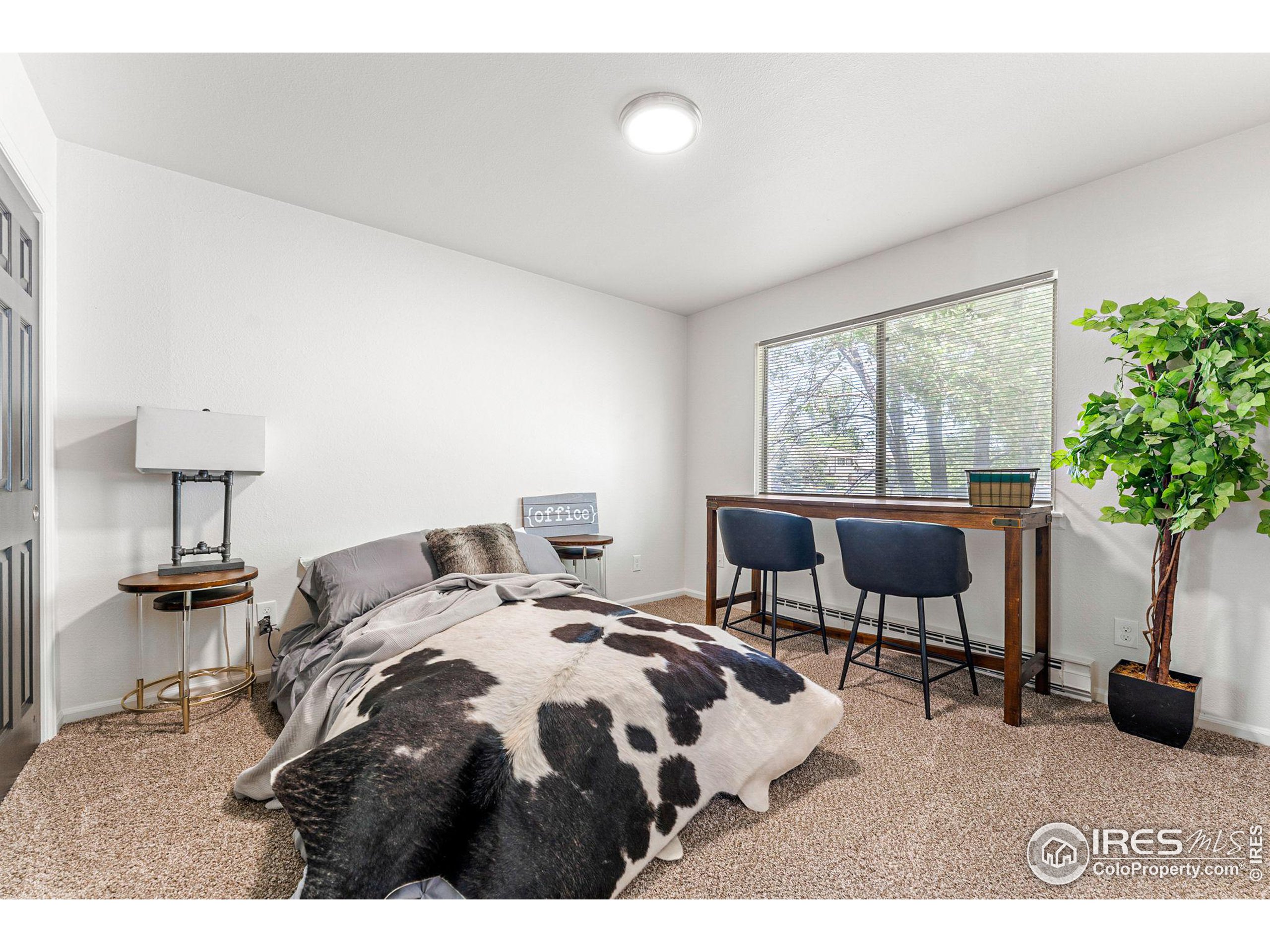 2408 Orchard Place Fort Collins, CO 80521 - Photo 18 of 36 a bedroom with a bed and a table