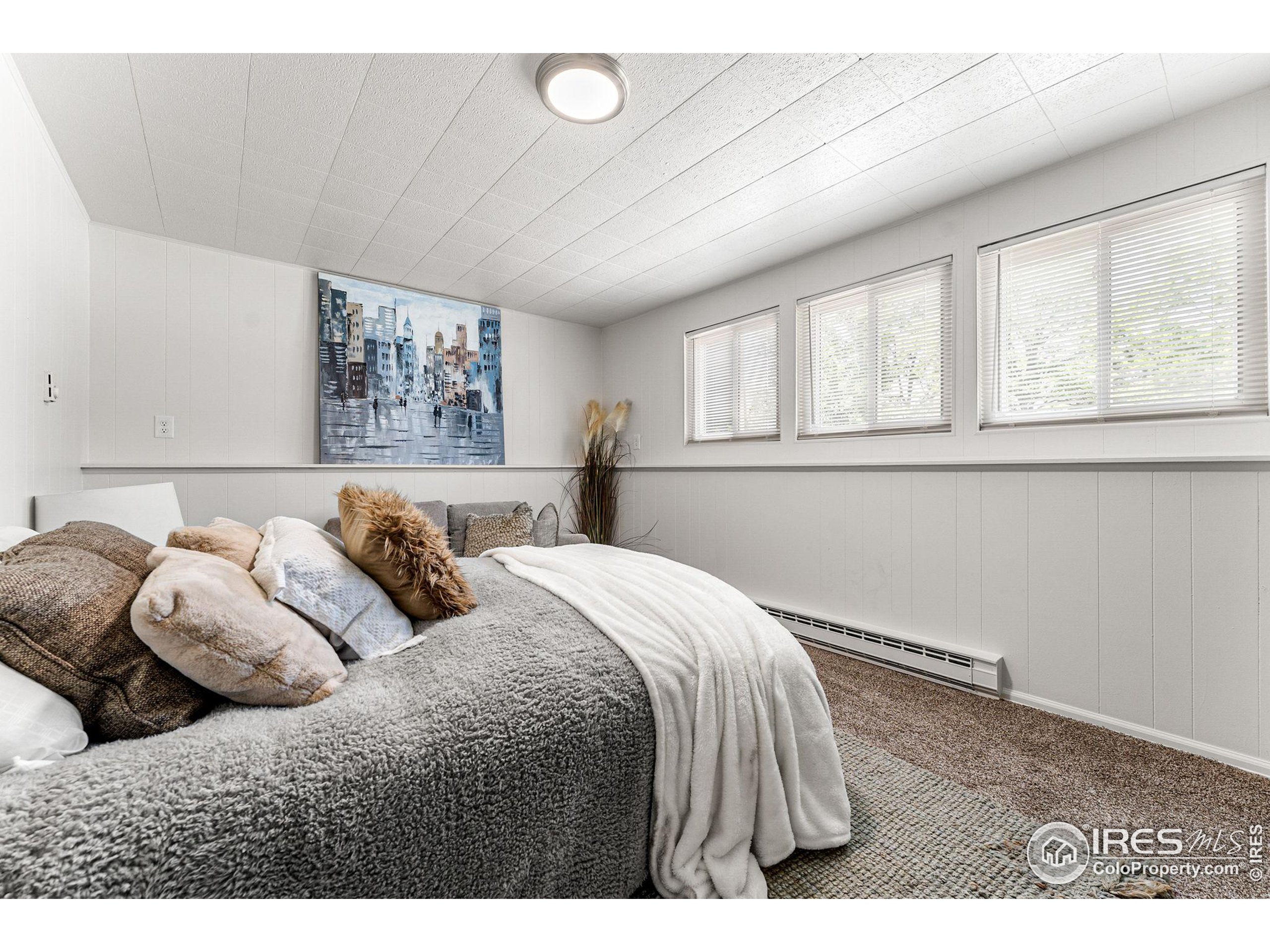 2408 Orchard Place Fort Collins, CO 80521 - Photo 21 of 36 a bedroom with a bed and a window