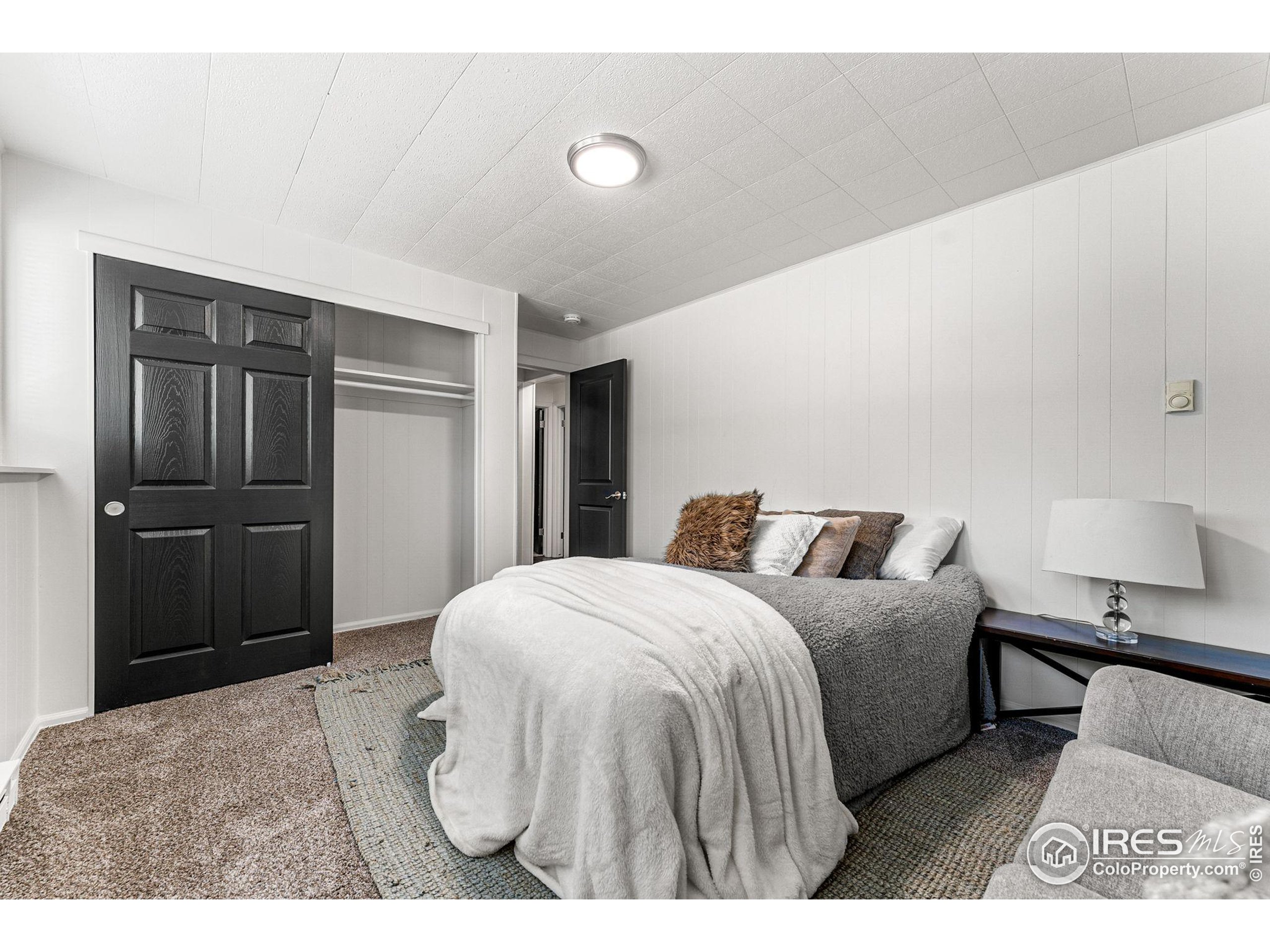 2408 Orchard Place Fort Collins, CO 80521 - Photo 22 of 36 a bedroom with a bed and a lamp
