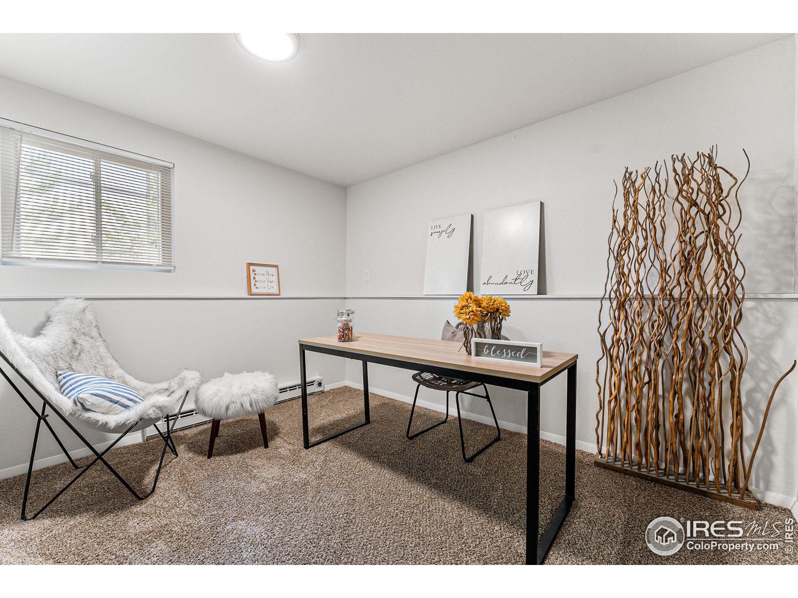 2408 Orchard Place Fort Collins, CO 80521 - Photo 23 of 36 a living room with furniture and a wooden floor