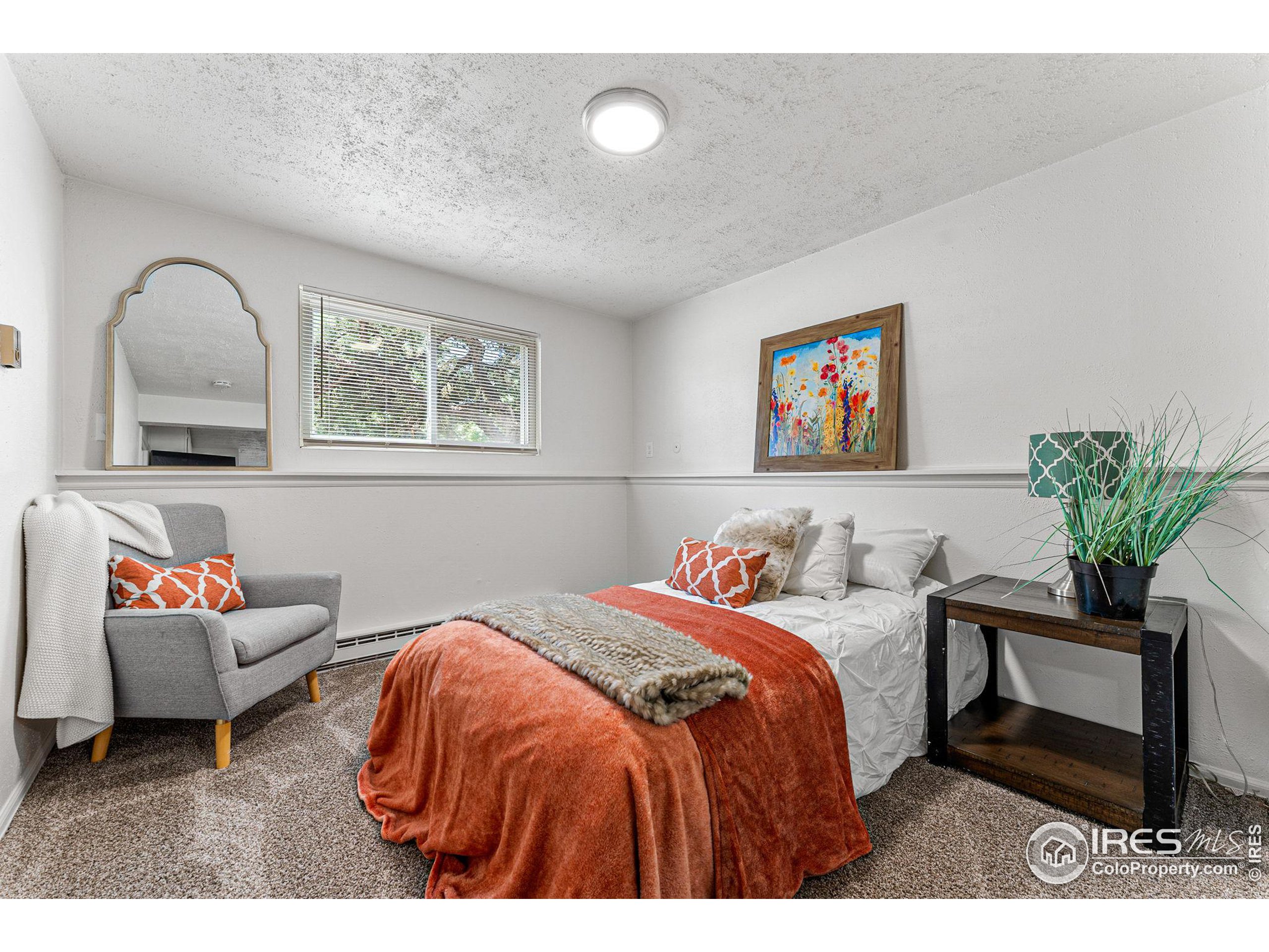 2408 Orchard Place Fort Collins, CO 80521 - Photo 25 of 36 a bedroom with bed and a potted plant