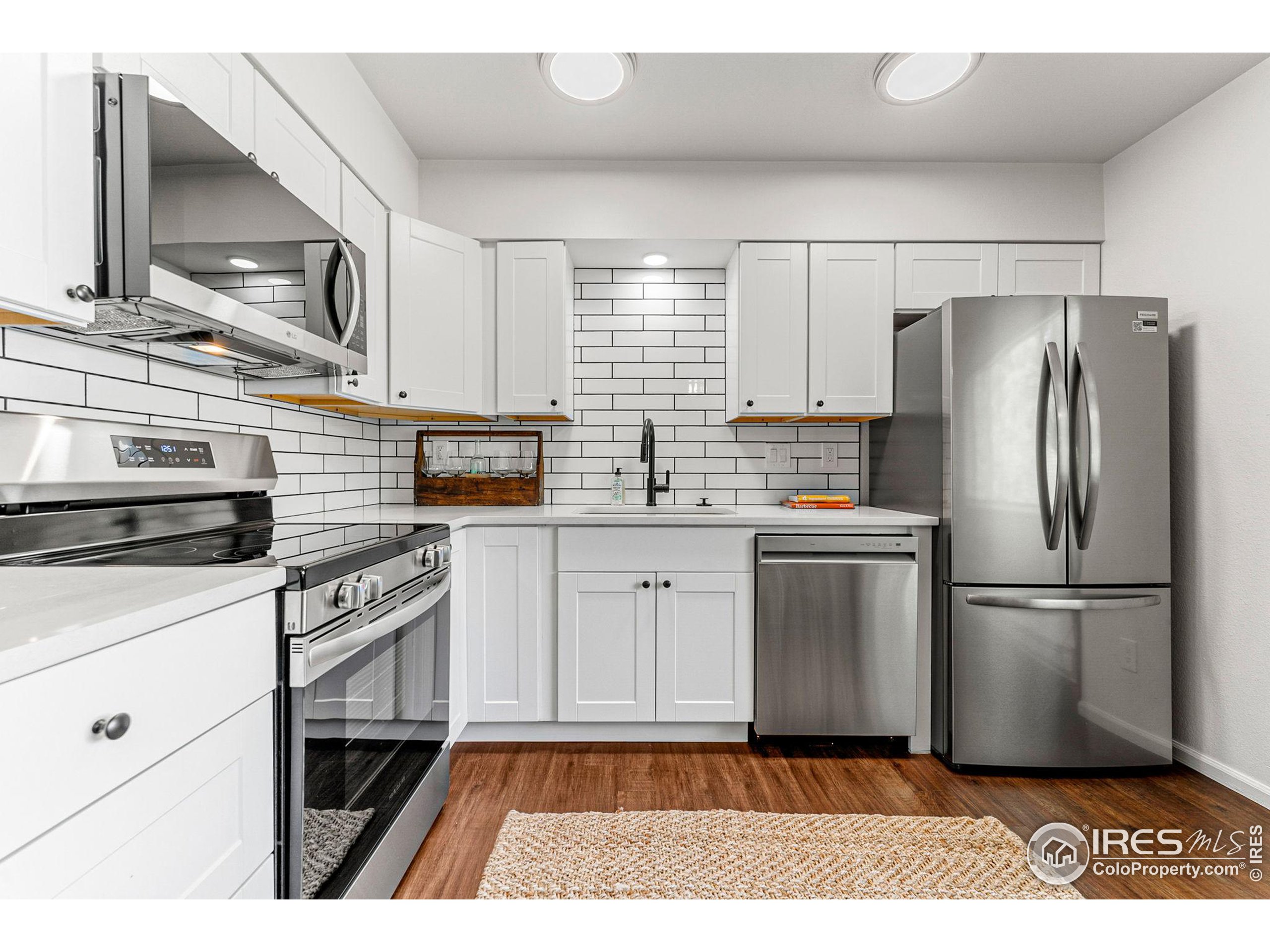 2408 Orchard Place Fort Collins, CO 80521 - Photo 8 of 36 a kitchen with a refrigerator stove and sink