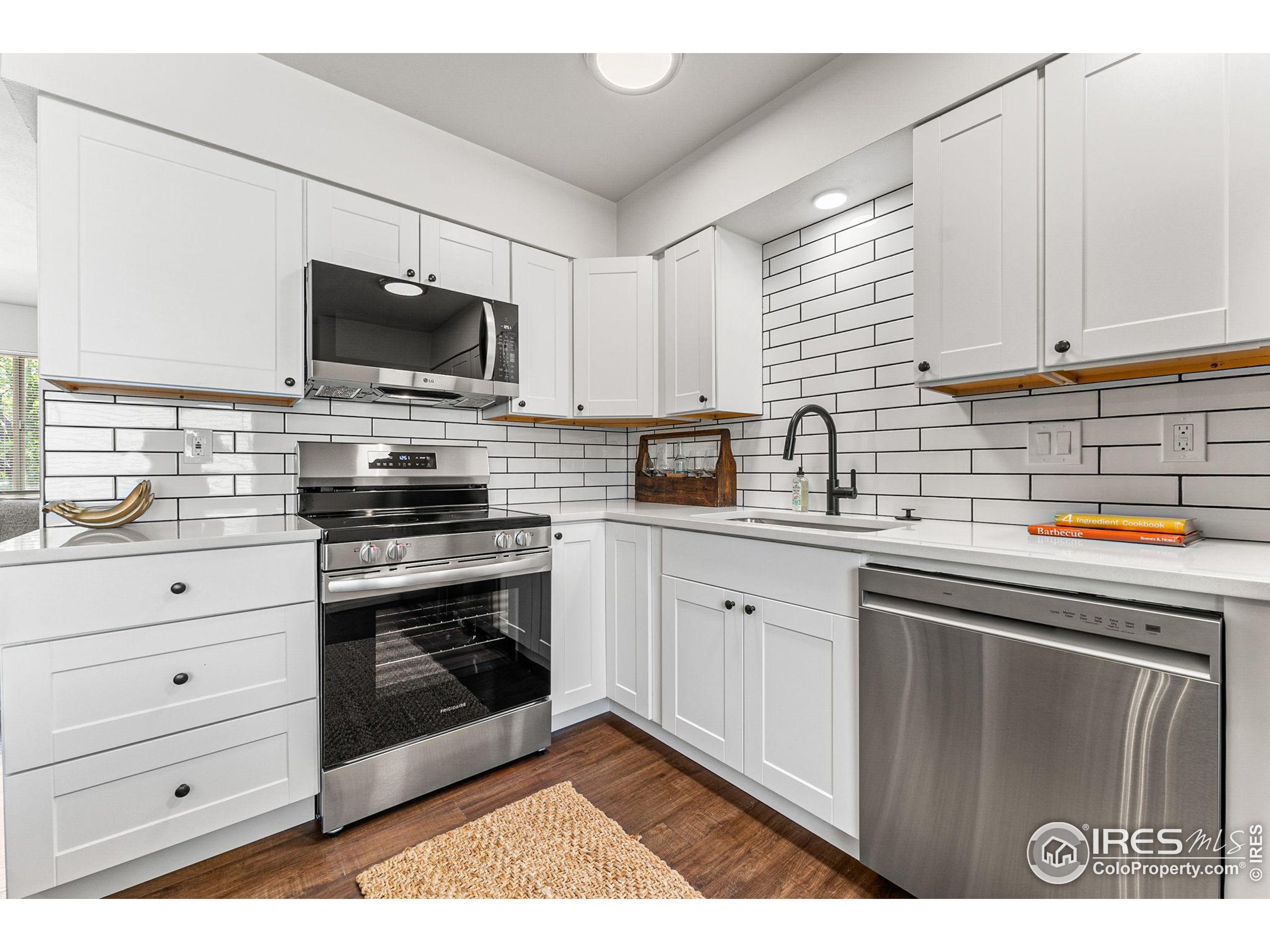 2408 Orchard Place Fort Collins, CO 80521 - Photo 9 of 36 a kitchen with stainless steel appliances a stove microwave and sink