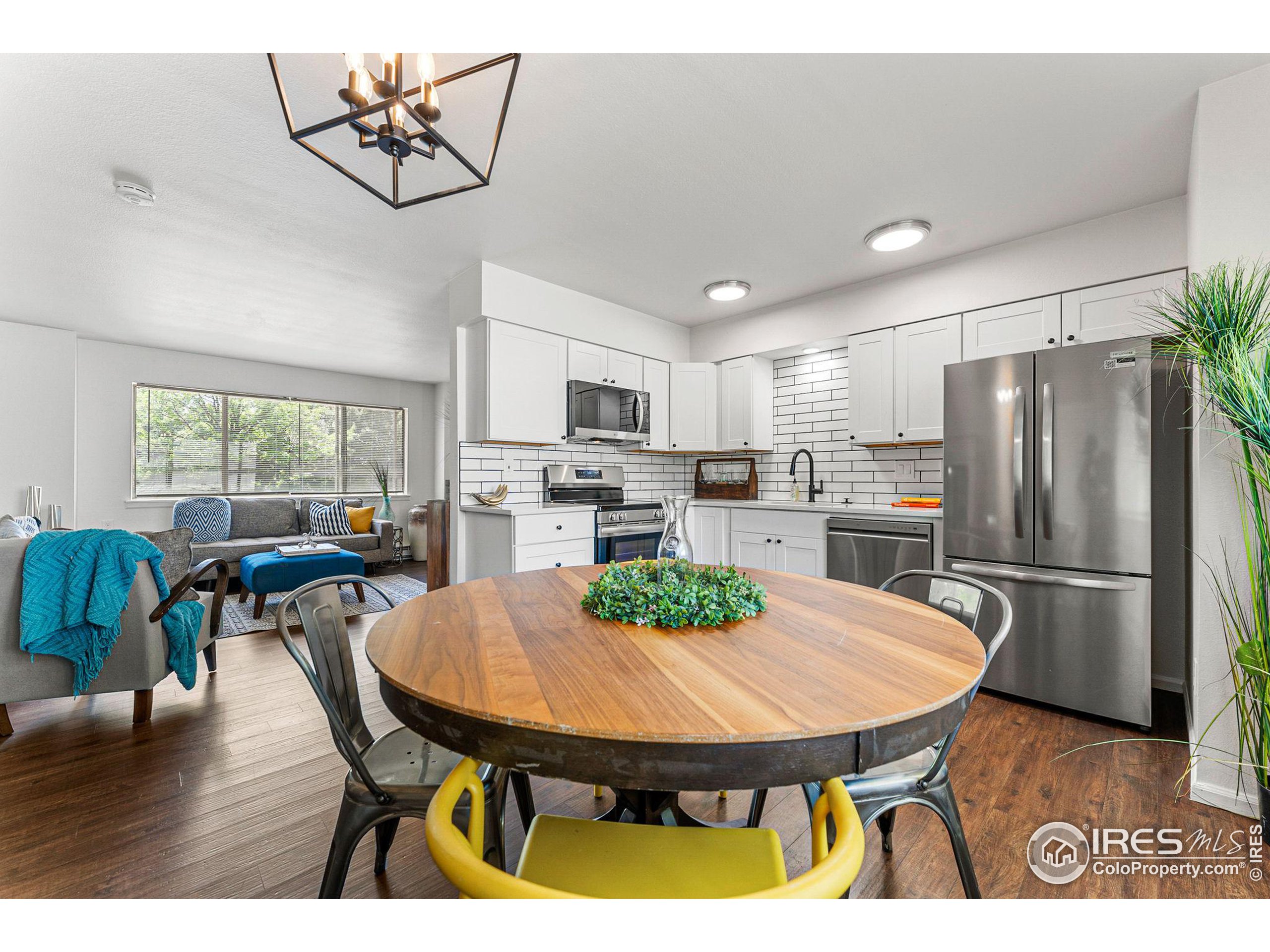 2408 Orchard Place Fort Collins, CO 80521 - Photo 10 of 36 a view of a dining room with furniture and wooden floor