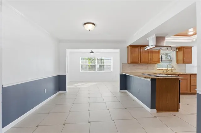 a large kitchen with granite countertop a sink and cabinets