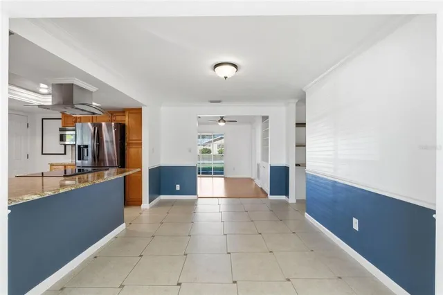 a large kitchen with stainless steel appliances a large counter top