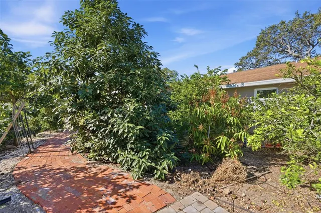 a view of a house with backyard and sitting area