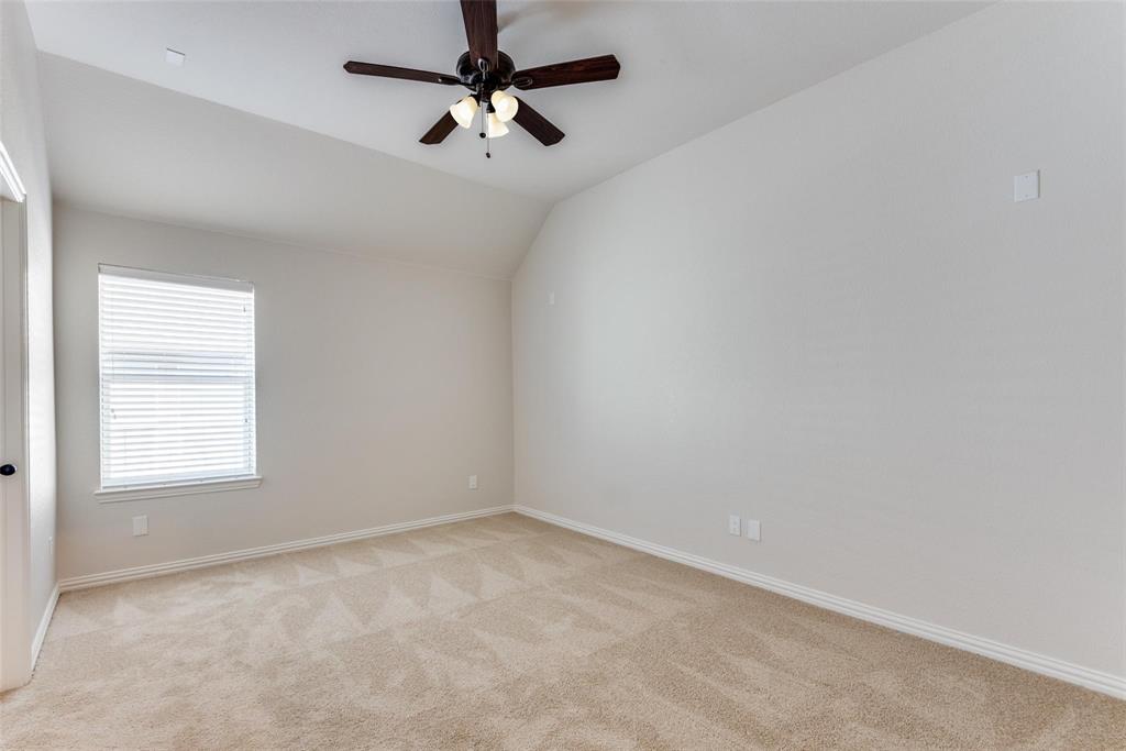 2344 Ranchview Drive Little Elm, TX 75068 - Photo 21 of 24 Room featuring neutral carpet flooring, white walls, a single window with blinds, a ceiling fan with dark wood-finish blades, and white trim