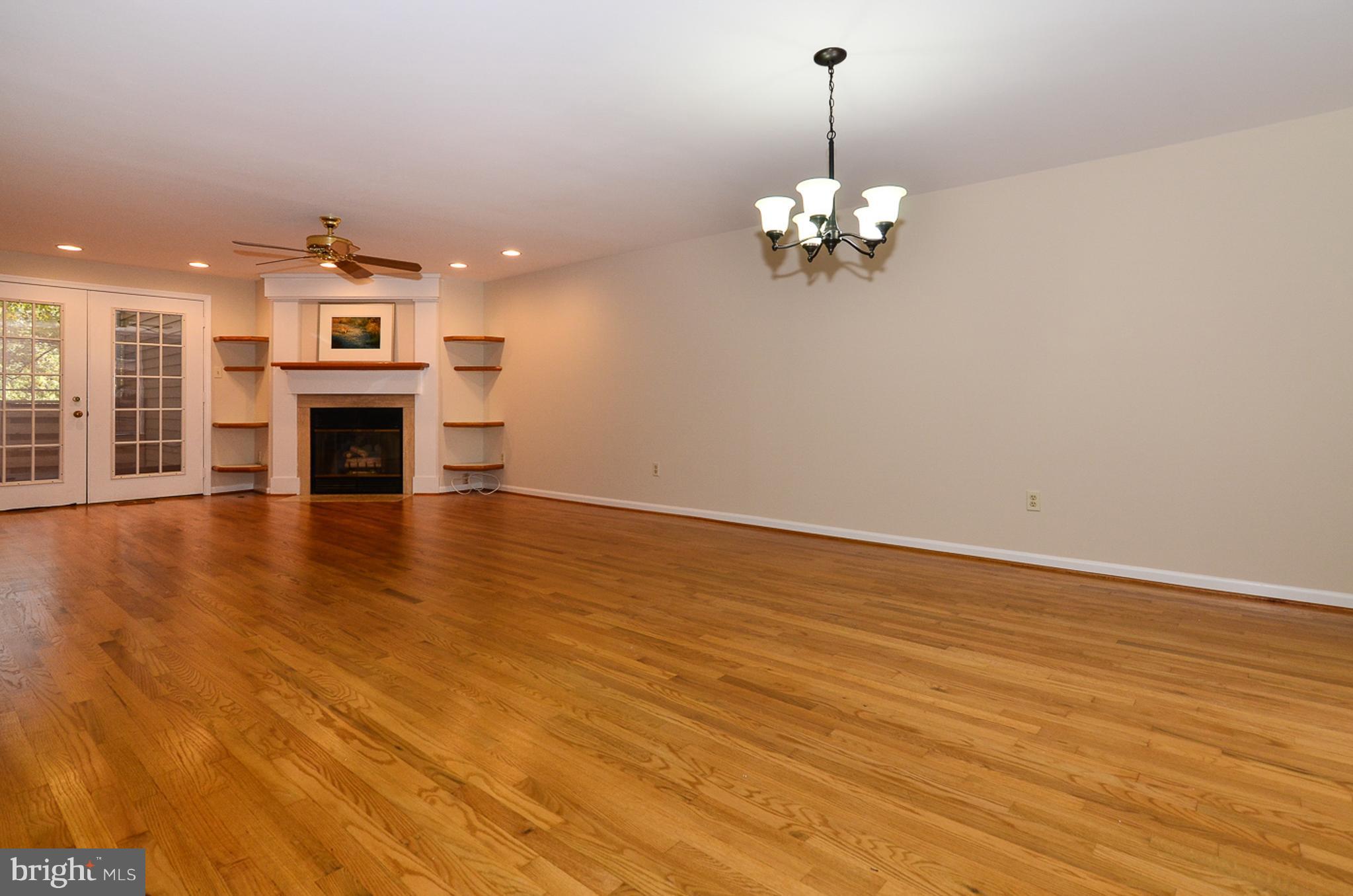 1558 Deer Point Way Reston, VA 20194 - Photo 2 of 22 a view of a room with chandelier fireplace and wooden floor