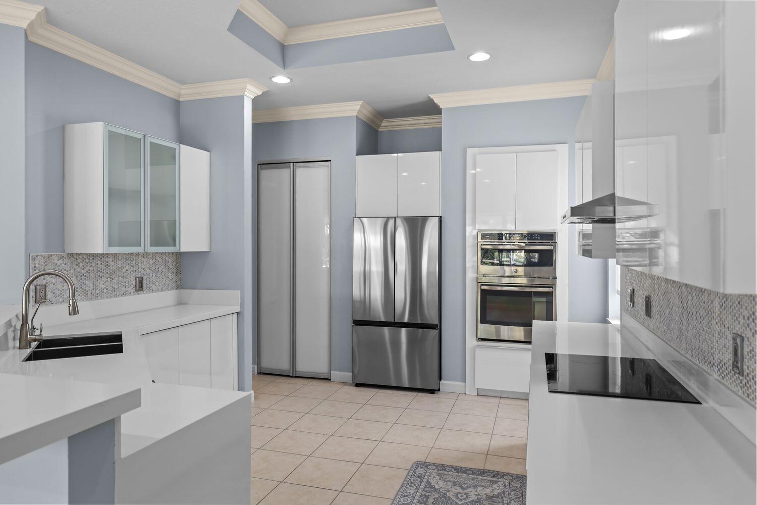 9152 Short Chip Circle Port St. Lucie, FL 34986 - Photo 16 of 72 a kitchen with stainless steel appliances a refrigerator and a sink